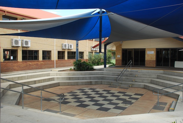 Outdoor amphitheatre with tiered seating and shade structure for performances and gatherings